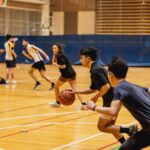 Students playing basketball inside Curtin Stadium.