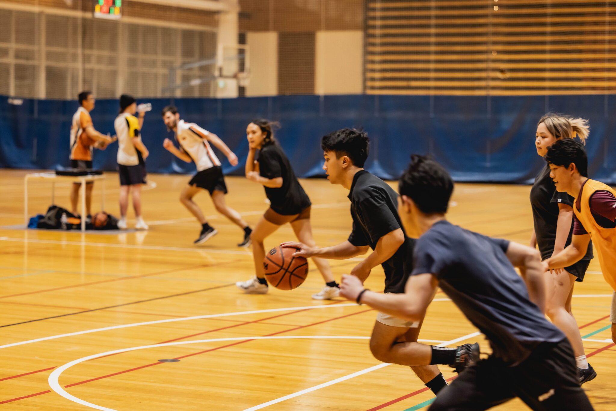Students playing basketball inside Curtin Stadium.