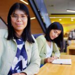 Student wearing a blue top studying