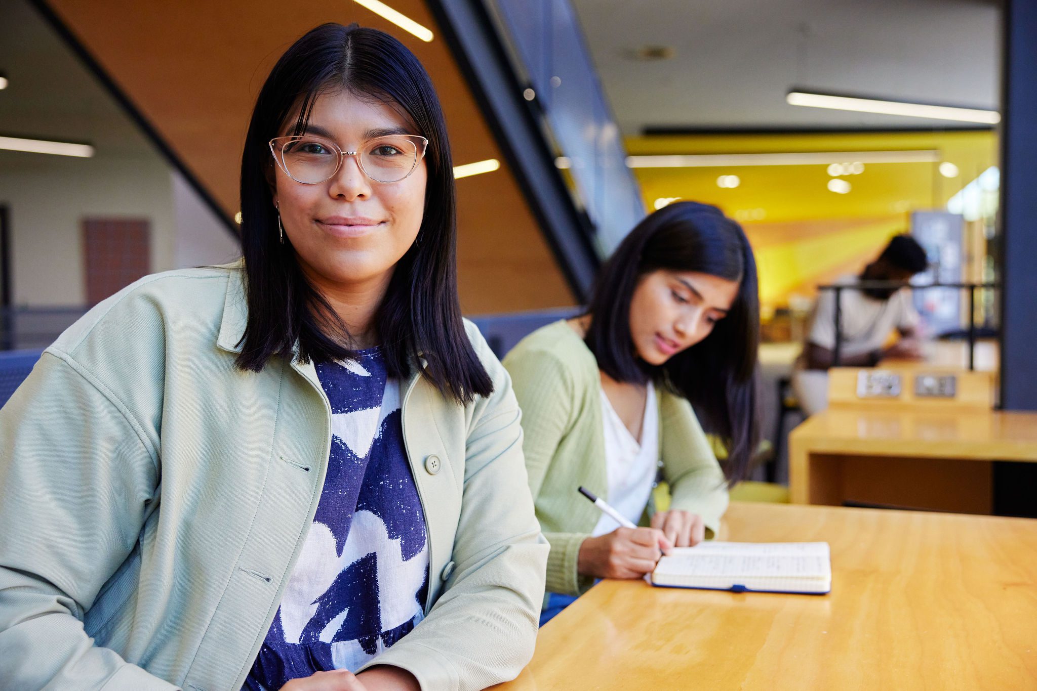Student wearing a blue top studying