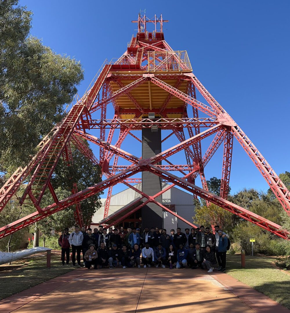 The new semester 2 2023 cohort in front of the Ivanhoe Headframe