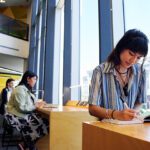 Student sitting in the library studying