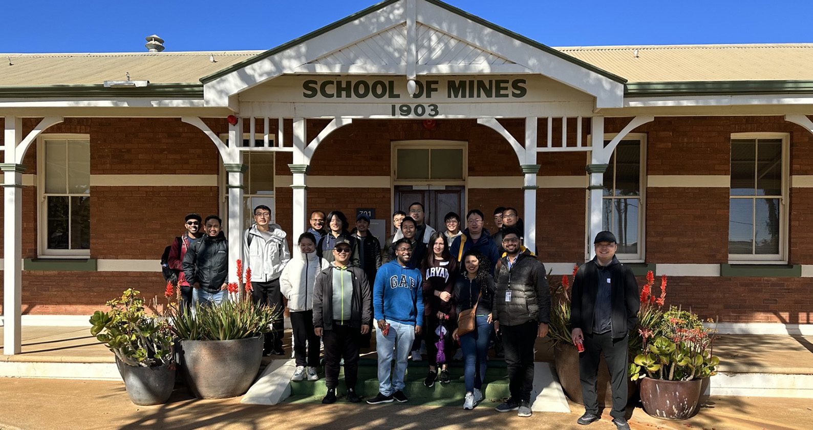 The new semester 2 2023 cohort in front of the School of Mines building