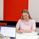 Two students sitting on a desk studying