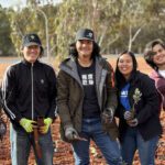 5 Curtin Kalgoorlie students smile at the camera during the Tree Planting event