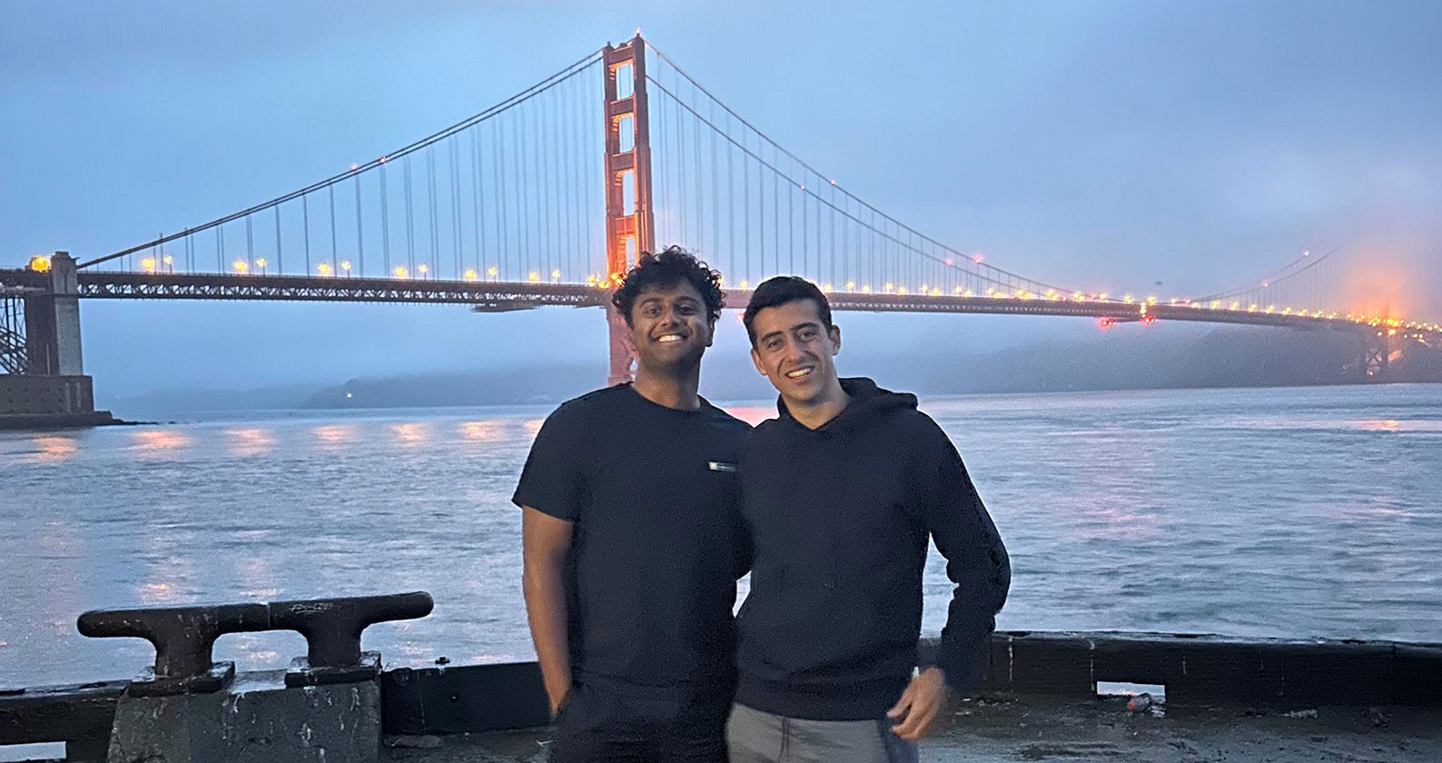 Melvin Tom and a friend in front of the Golden Gate Bridge.