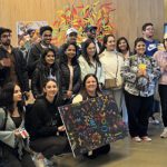 FBL International students take a group photo at Bilya Koort Boodja, holding their collective dot painting.