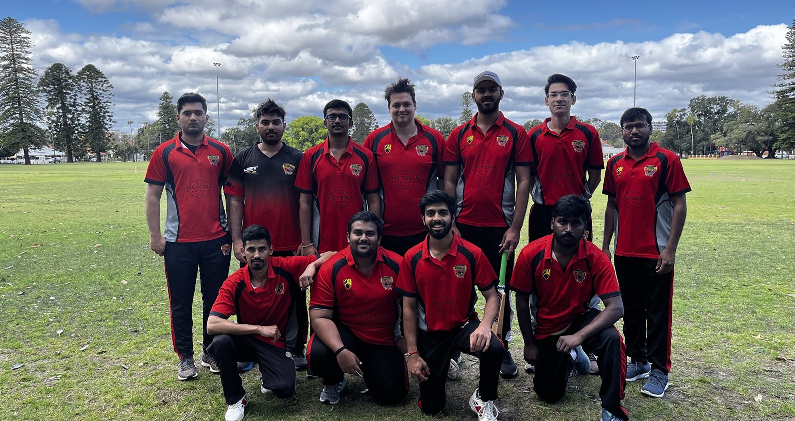 A group of Science and Engineering international students who took part at the staff vs students cricket match. They wear red shirts to represent their team.