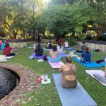 Students attending an outdoor yoga class.