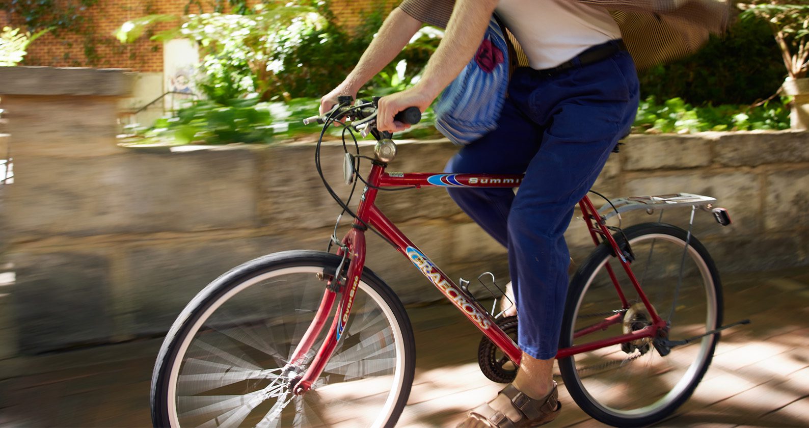 Student riding a bike on campus.