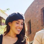 Two students smiling walking on campus together.