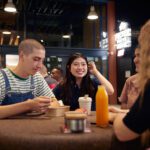 Students smiling at a cafe
