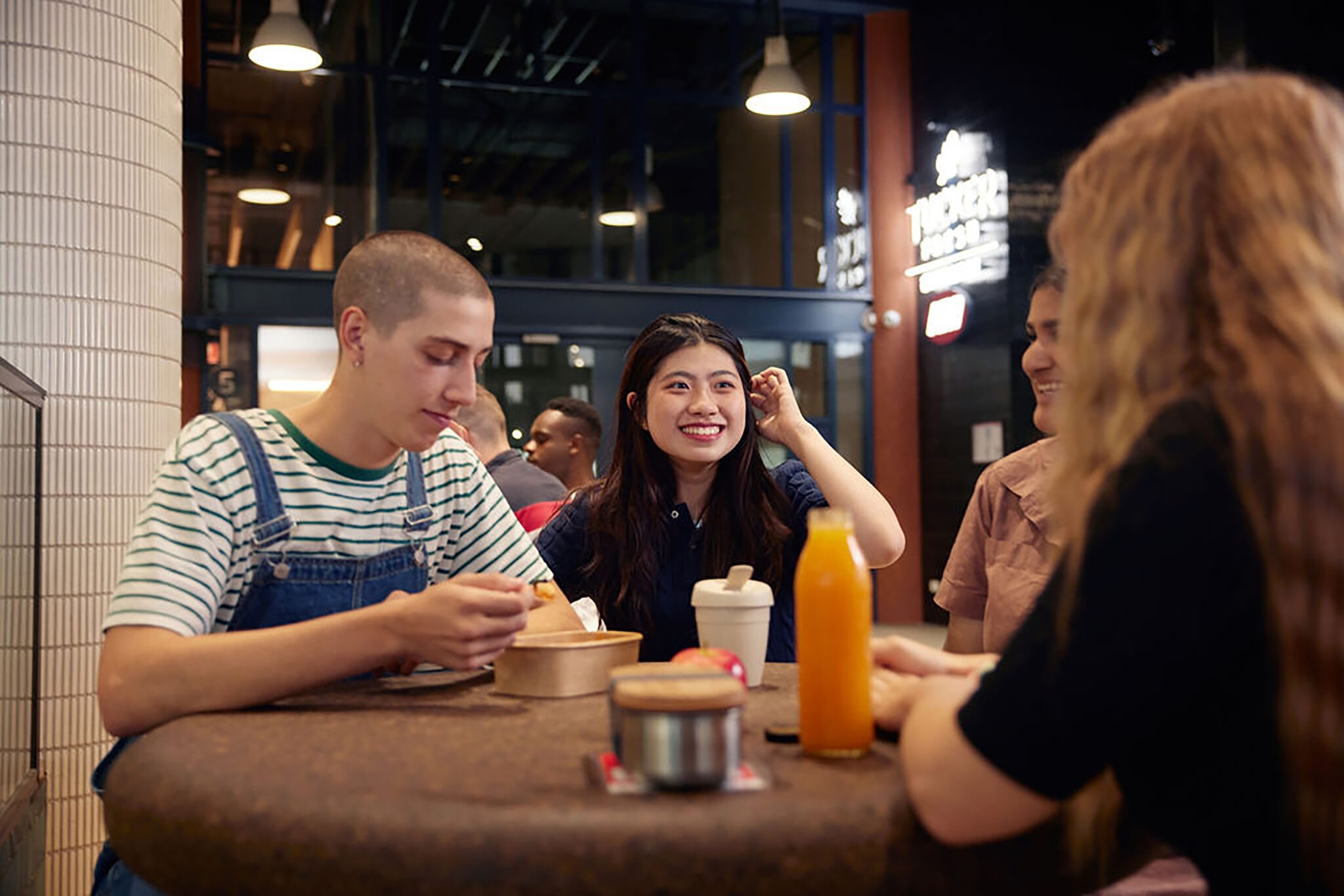 Students smiling at a cafe
