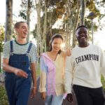 Three students walking through campus