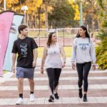 Three students walking along a path at Curtin Stadium.
