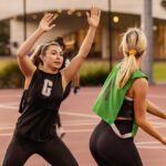 Two students playing netball.