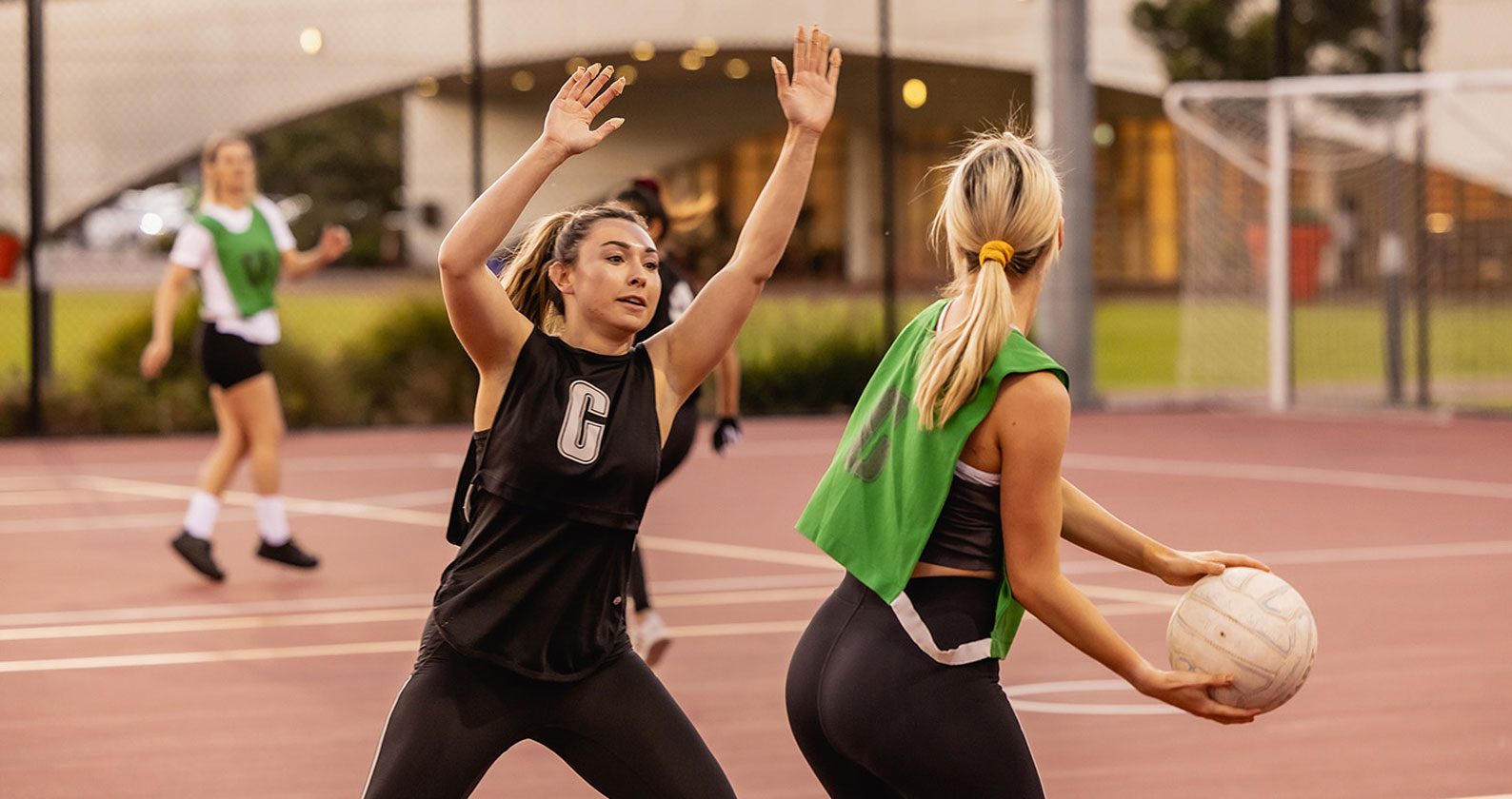 Two students playing netball.