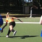 A group of students playing hockey.