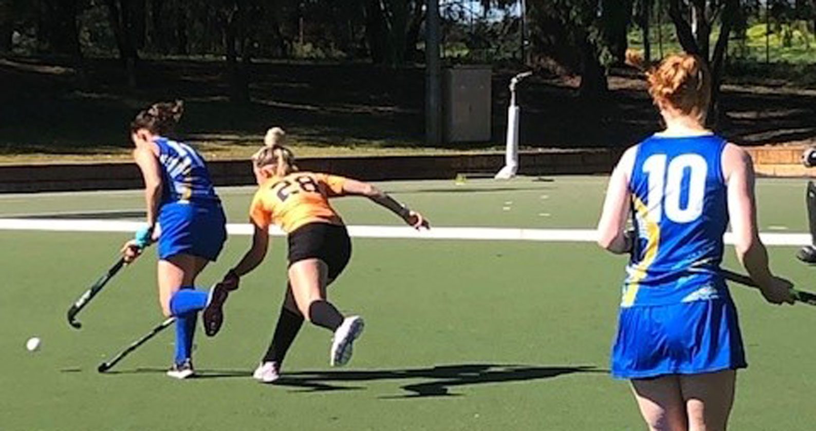 A group of students playing hockey.