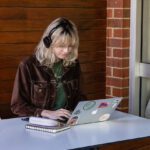 Student sitting at desk on device