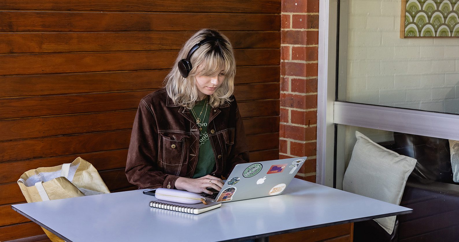 Student sitting at desk on device