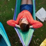 Three students lying down in hammocks