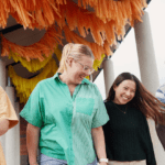 Four students standing together smiling