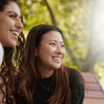 Two students smiling into the distance. The Insight logo is in the top right hand corner.
