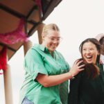 three students walking and laughing together
