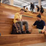 Students sitting on the TL Robertson Library stairs talking