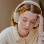 Student wearing headphones studying.