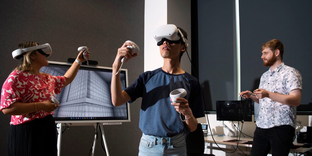 Three students learning VR technologies.