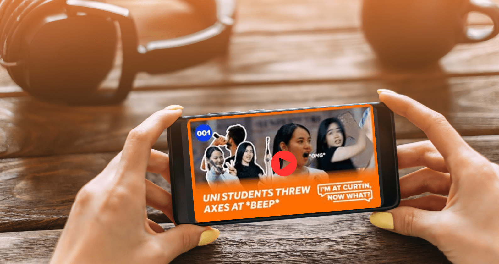Someone holding an iPhone with the latest I'm At Curtin Now What video playing.