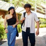 Two students walking through Curtin Perth campus.