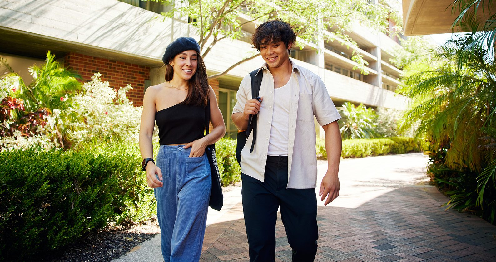 Two students walking through Curtin Perth campus.