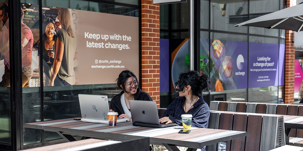 Two Curtin students chatting in the Exchange precinct