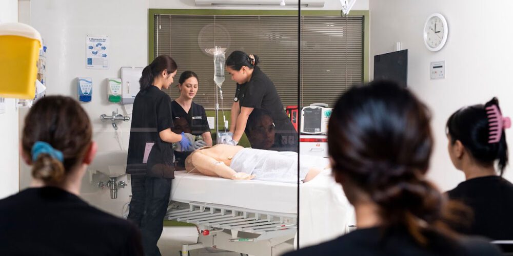Curtin nursing students working on a patient.