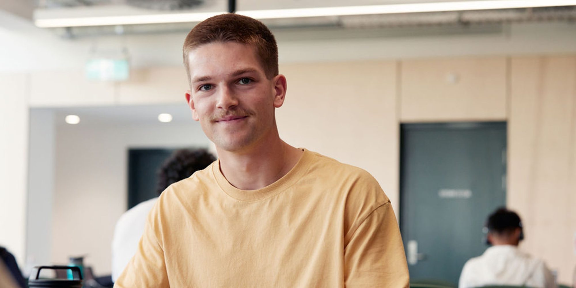 Student in the library smiling