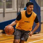 Student playing basketball at Curtin Stadium.
