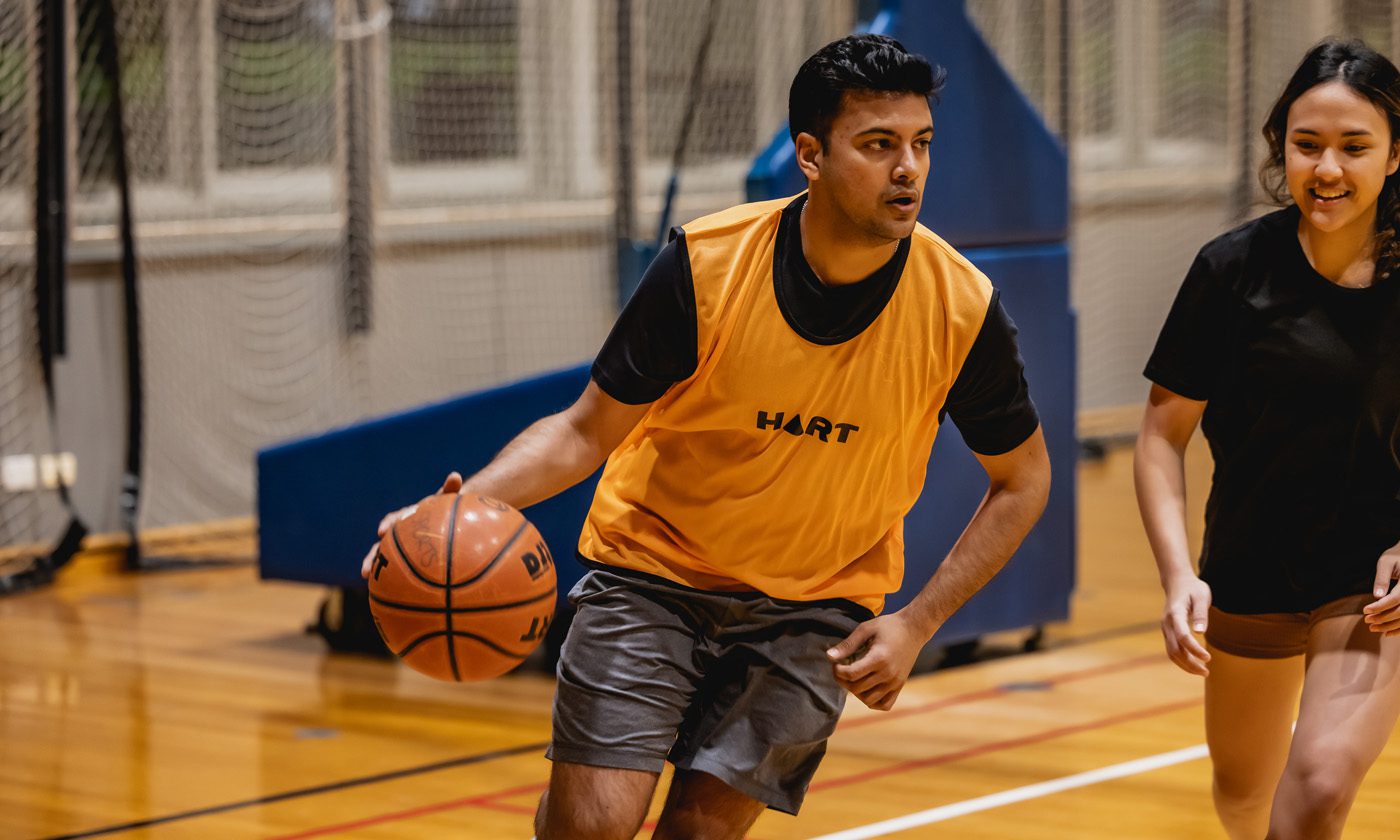 Student playing basketball at Curtin Stadium.