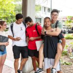 A group of students laughing and socialising.