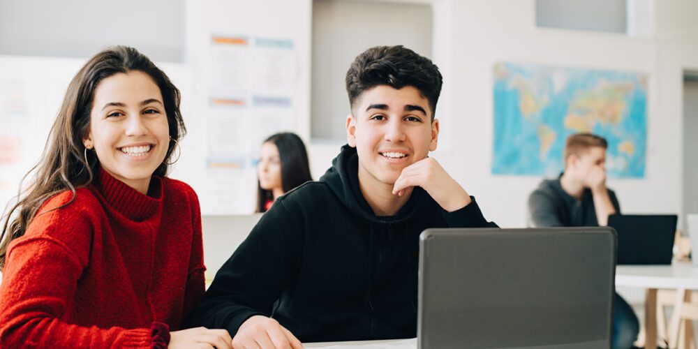 Two high school students smiling at the camera