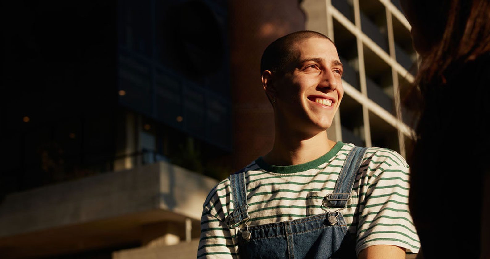 Student smiling into the distance.