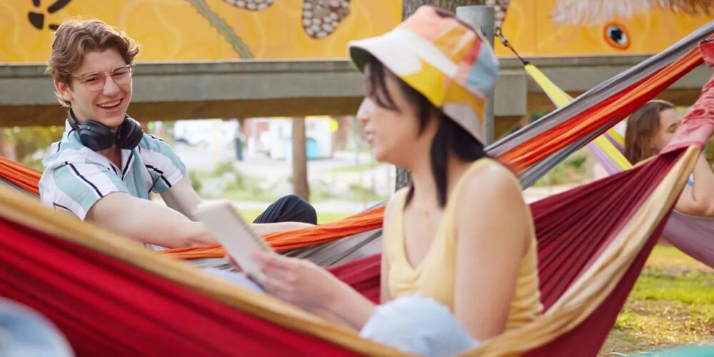 Two Curtin University students enjoying the Hammock Hotel.