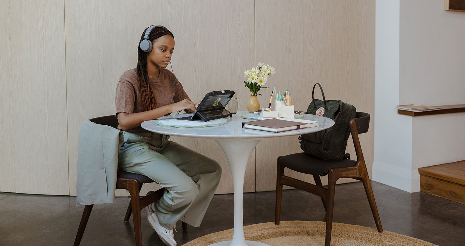 A student studying at home on her laptop.