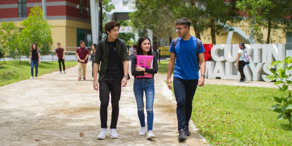 Three Curtin University students on the Curtin Malaysia campus.