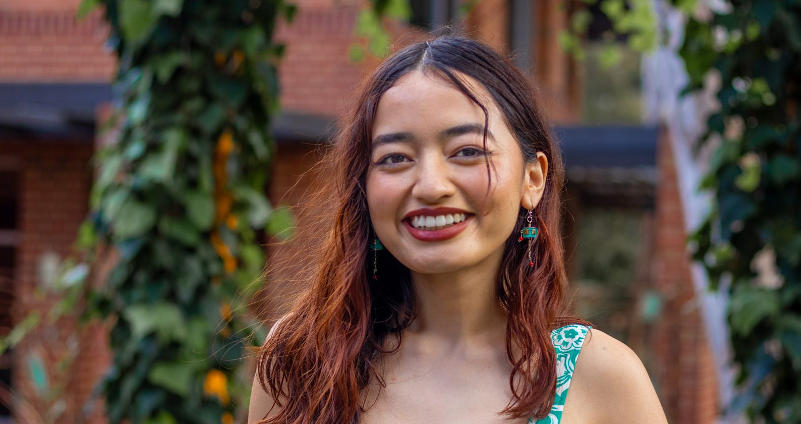 Biji, a Curtin Marketing student smiles on campus.