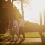 A group of students walking on a path in the sun,