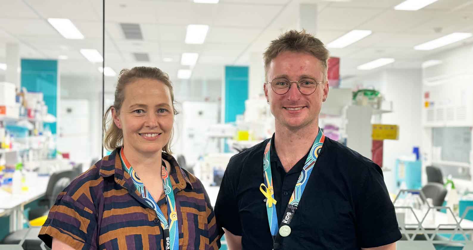 Mike and Shannon stand in front of a lab.