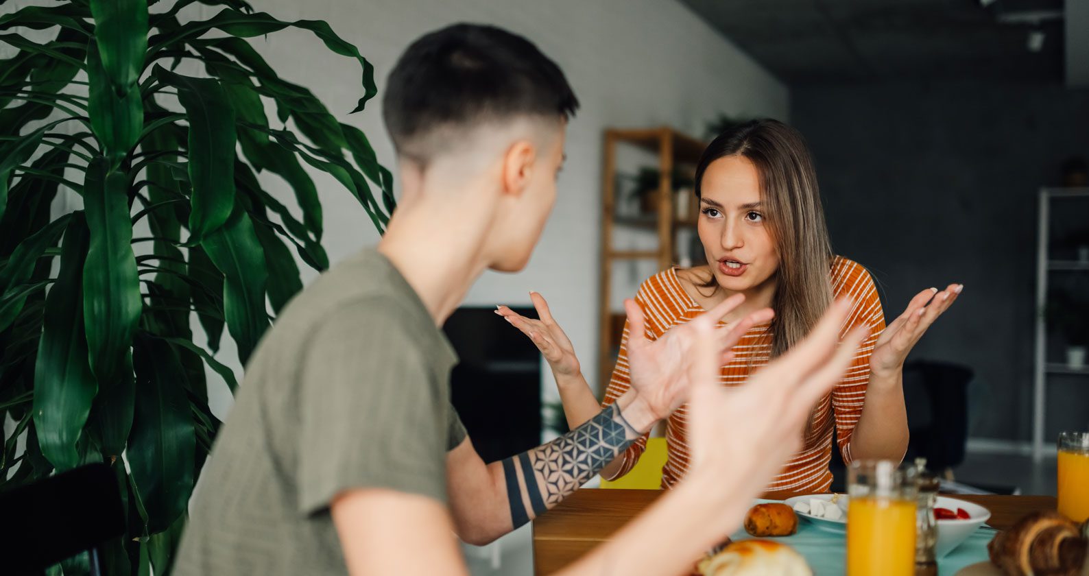Two students fighting over a breakfast table.